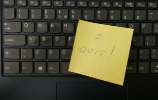 a yellow notepad on a keyboard