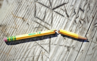 yellow pencil on gray wooden surface