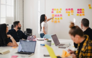 woman placing sticky notes on wall