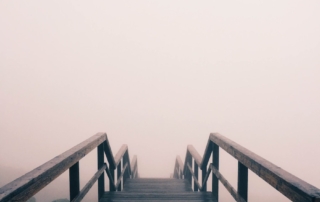 black wooden stairway covered with fog
