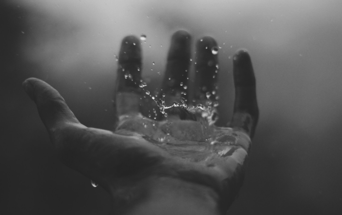 time lapse photography of water hitting left palm